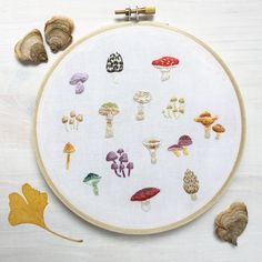 an embroidery project with mushrooms and leaves