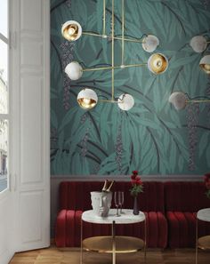 a living room with red velvet couches and gold chandeliers hanging from the ceiling