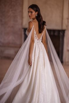 a woman in a wedding dress with a veil on her head