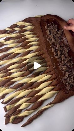 a large piece of chocolate cake sitting on top of a white table