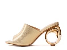 Gold Heels With Metal Feet For Summer, Summer Mules With Metal Feet And Round Toe, Modern Gold Heels With Deep Heel Cup, Modern Gold Sandals With Open Heel, Spring Gold Sandals With Sculpted Heel, Gold Heels With Deep Heel Cup In Modern Style, Gold Sandals With Sculpted Heel For Spring, Gold Sandals With Open Heel, Modern Style, Spring Gold Trendy Mules