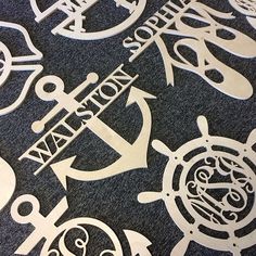 an assortment of cut out signs and symbols on a black carpeted floor with white lettering