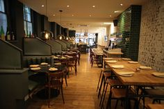 an empty restaurant with wooden tables and chairs