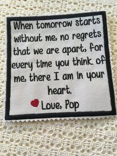 a piece of cloth with a poem written in black and white on the bottom, along with a red heart