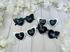 six heart shaped sunglasses with the word mr and mrs written on them next to white flowers