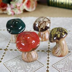 three small mushrooms sitting on top of a table