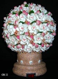 a vase filled with white and pink flowers