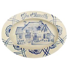 a blue and white plate with the words, the glassell on it's side