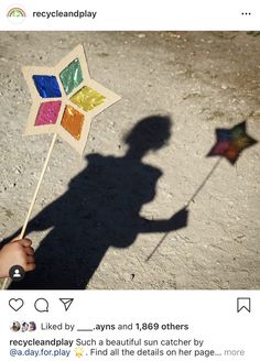 a shadow of a person holding a colorful pinwheel