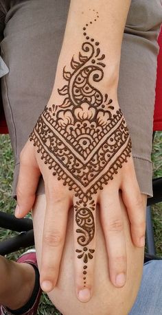 a woman's hand with henna on it