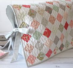 a quilted pillow sitting on top of a wooden floor