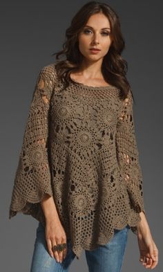 a woman wearing a sweater with crochet on it