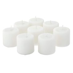 white candles are arranged in rows on a white background