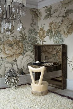 a chair sitting on top of a shaggy rug in front of a wallpapered room