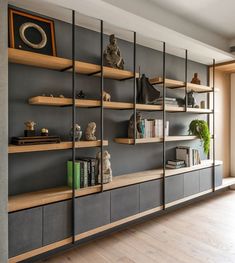 a living room filled with lots of furniture and shelves next to a wall mounted bookshelf