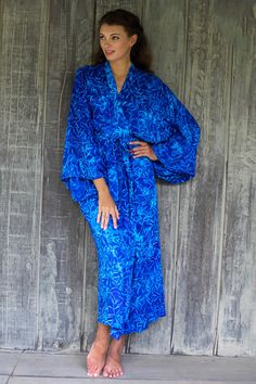 Cerulean bamboo leaves sway and dance over the royal blue rayon textures of this stylish robe from Indonesia. Perfect to lounge in for those lovely stress-free moments the long-sleeve robe is crafted with traditional Balinese tie-dye and batik techniques. Side-seam pockets and a self-tie belt complete the robe's design. Fair Trade Clothing, Batik Art, Bamboo Leaves, Batik Print, Batik Prints, Balinese, Wide Sleeves, Tie Dyed, Textile Design