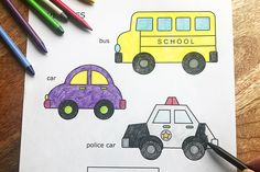 a child's hand is holding a crayon pencil and drawing cars on paper