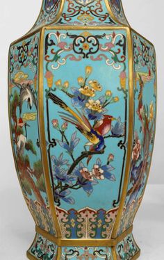 an ornate vase with birds and flowers painted on it