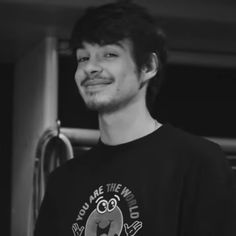 a man standing in front of a refrigerator wearing a t - shirt that says, you're the world