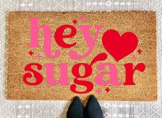 someone standing in front of a door mat that says hey sugar