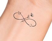 a small tattoo on the wrist of a woman's left arm with an infinite symbol