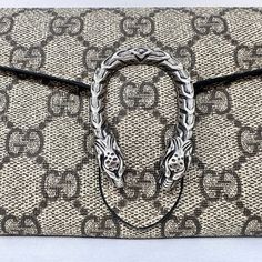 Gucci GG Mini Dionysus Wallet on the Chain (with Dustbag and Box) Designer = Gucci Color = Brown Material = Coated Canvas Condition = Excellent Height = 4 Width = 7.5 Depth = 1 1/2" Class = Premier Location: Wilmette Item Number: 19740-125 Item ID: 298128 Category: Mini Bag Elegant Gucci Wallet On Chain As Gift, Designer Gucci Silver Bag, Silver Gucci Evening Bag, Designer Silver Gucci Bags, Luxury Rectangular Wallet With Chain, Luxury Chain Wallet In Rectangular Shape, Luxury Silver Wallets, Luxury Rectangular Chain Wallet, Rectangular Wallet On Chain Gift