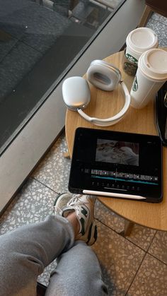 a person sitting at a table with an ipad