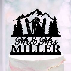 a wedding cake topper that says mr and mrs miller with skis on it