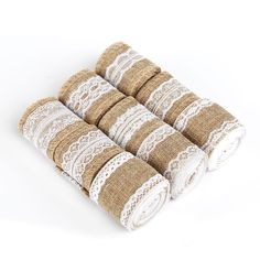 four rolls of burlock lace on top of each other in brown and white