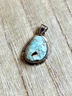 This vintage Small Navajo Sterling silver pendant features a rare high polish Dry Creek turquoise with its symbolic rare pastel blue natural color. Fine and delicate.  Please see last picture for pendant measurement, compare to quarter coin. Weight: 4.1 grams Signed: JF Sterling Dry Creek Turquoise comes from a small Turquoise mine outside of Austin, Nevada in Lander County. This mine was previously known for its sky blue to medium blue webbed turquoise. Dry Creek Turquoise has gained much popularity over the years with its creamy pale blue coloring and golden to cocoa brown matrix. This color of Turquoise was rarely used in Turquoise Jewelry before the late 1990s. The color is a pastel blue much like the color of Larimar, only high grade Dry Creek Turquoise has beautiful light brown, gold Southwestern Turquoise Necklace With Large Stone, Southwestern Engraved Turquoise Necklace, Southwestern Style Blue Turquoise Oval Pendant Necklace, Southwestern Blue Turquoise Oval Pendant Necklace, Engraved Southwestern Turquoise Necklace, Southwestern Style Turquoise Necklace With Oval Pendant, Southwestern Blue Oval Pendant Jewelry, Collectible Turquoise Round Pendant Necklace, Collectible Turquoise Necklace With Round Pendant