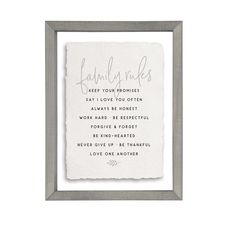 a framed print with the words, family rules and handwritten text in grey frame