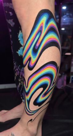 a person with colorful tattoos on their legs