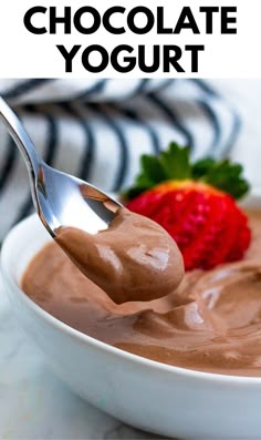 chocolate yogurt in a white bowl with a spoon and strawberries on the side