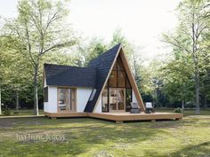 a - frame house in the middle of a field with trees around it and grass on the ground