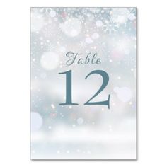 a table number card with snowflakes in the background and text that reads, table 12