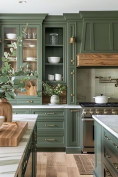 a kitchen with green cabinets and white counter tops