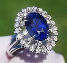 A Breathtakingly Striking HANDMADE 14k White Gold Ring with Beautiful Oval Cut Sapphire in Blue color! The GEM is 3.31CT and measures 10.05x7.23x5.77 mm! This Stone will take your breath away, especially on the sunlight! You will want to look at this stone endlessly. The mounting is a masterpiece! HANDMADE 14K White Gold Diamond Mounting (tested), that was is custom made to Accommodate this Beauty of a Gem in a V-prongs setting! Super FINE Workmanship on the Diamond v-split setting with 32 pcs Brilliant Full Cut Diamonds in GH color, SI1 clarity, totaling to approx  0.49CT ! Fabulous Braided Band and Diamond Gallery! The Entire Top's outline is 17.3x14.7 mm- HUGE. The Ring weights 6.4 g, nice and SOLID. Sits 8.6 mm off the top of the finger. Finger size 7(Free Re-sizing with purchase). Cen Luxury Oval Gemstones With Halo Setting, Oval Diamond Gemstones For Formal Occasions, Formal Oval Diamond Gemstones, Gia Certified Sapphire Cluster Jewelry, Exquisite Oval Brilliant Cut Gemstones, Exquisite Oval Brilliant-cut Gemstones, Gia Certified Oval Sapphire Ring In Platinum, Luxury Oval Platinum Gemstones, Exquisite Oval Platinum Gemstones