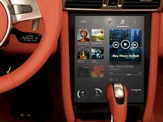 an image of the inside of a car with music playing on the touch screen and steering wheel