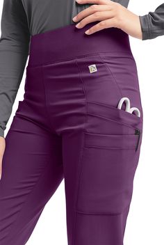 The ReSurge by Butter-Soft Sapphire Women s 6-Pocket Yoga Inspired Scrub Pants feature a modern natural waisted fit with a tapered leg. Wide rib-knit waistband sits at natural waist and the wide elastic is made using recycled materials. It also has flattering front and back seams that contour to your body shape. For storage there are a total of 6 pockets; 4 roomy cargo pockets, right side has pen pocket, and 1 small items pocket with concealed zip closure on wearers right hip. Made of polyester Yoga Scrub Pants, Easy Stretches, Purple Reign, Women Cargos, Scrub Pants, Casual Style Outfits, Yoga Inspiration, New Print, Body Shape