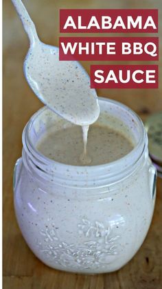 white bbq sauce in a mason jar with a spoon