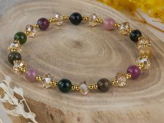 Elevate your style with our handcrafted bracelet, meticulously designed with a captivating blend of dopamine-infused tourmaline, crystal, and silver beads plated in radiant gold. Each bead exudes elegance and positive energy, making it perfect for the modern woman. The harmonious fusion of tourmaline and crystal in a dopamine-inspired color palette adds vibrancy and charm to any ensemble. With a length of 16cm, this bracelet is a stunning statement piece that complements any occasion, leaving a lasting impression wherever you go. Key Features: Handcrafted bracelet featuring a blend of dopamine-infused tourmaline, crystal, and silver beads plated in radiant gold. Dopamine-infused beads enhance mood and well-being, elevating your style with positive energy. Dopamine-inspired color palette ad Rainbow Tourmaline, Tourmaline Bracelet, Bracelet Crystal, Tourmaline Jewelry, Handcrafted Bracelets, Tourmaline Crystal, Bracelet Argent, Crystal Bracelet, Bracelet Silver