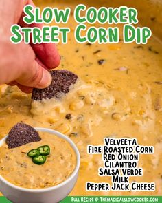 a hand dipping a tortilla chip into a bowl of slow cooker corn dip