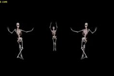 three skeletons standing in the dark with their arms outstretched