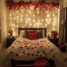 a bedroom decorated in red and white with hearts on the bed, lights behind it