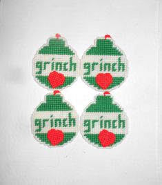 three christmas ornaments with the word grin on them are hanging from a white background,