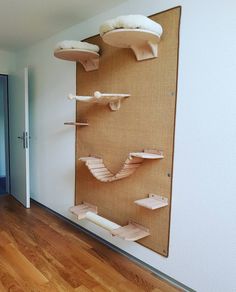 a room with wooden floors and shelves on the wall that are decorated with paper birds