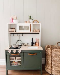 a kitchen with a stove top oven sitting next to a basket