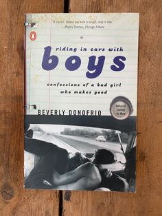 a book with the title riding in cars with boys written on it sitting on a wooden surface