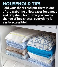 a shelf filled with lots of folded sheets and pillow cases on top of each other