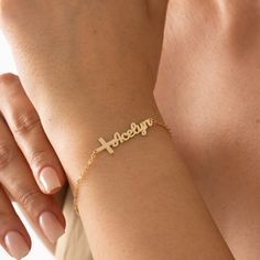 Introducing our beautiful Cross Name Bracelet, a unique and personalized piece of jewelry that combines faith and individuality. This bracelet features a delicate cross charm, symbolizing love, hope, and spiritual connection. The charm is accompanied by a customizable nameplate, where you can engrave the name of your choice. Crafted with care, this bracelet showcases a dainty design that is both elegant and meaningful. Made from high-quality materials, it ensures durability and lasting beauty. Whether it's a special gift for a loved one or a meaningful accessory for yourself, the Cross Name Bracelet is a perfect expression of faith and personal identity. It's suitable for everyday wear or to complement formal attire. Embrace the power of faith and let your name shine with this exquisite Cr Bracelet With Name, Personalized Cross, Bracelet Christmas, Custom Bracelet, Personal Identity, Beautiful Cross, Bracelet Display, Spiritual Connection, Baptism Gifts